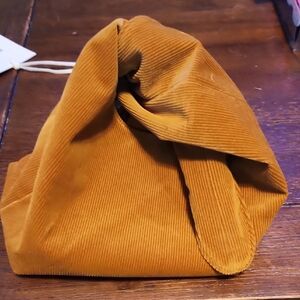 Merit Cosmetic Corduroy Knot Bag in Mustard Yellow
